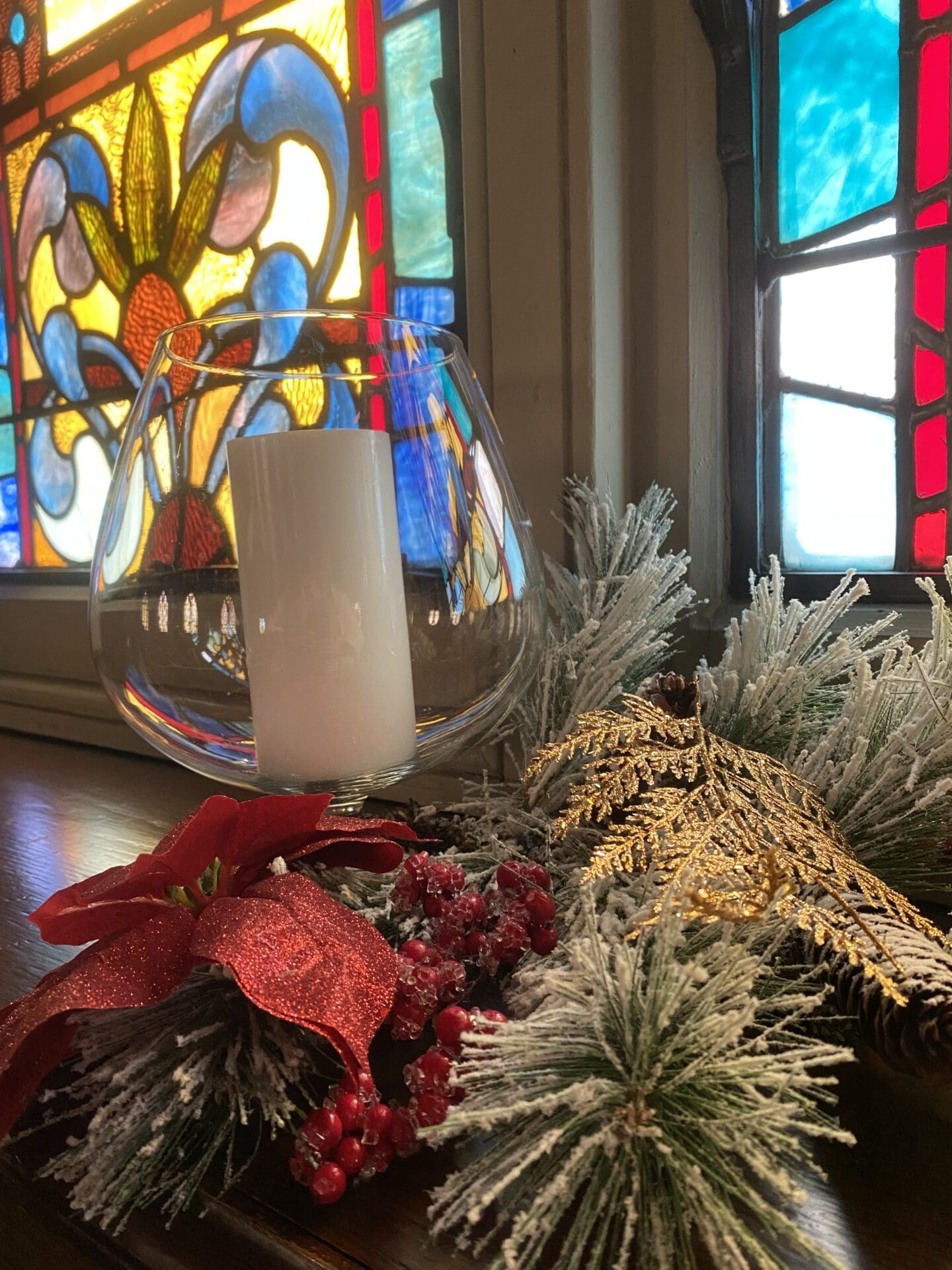 Christmas ornament with a white candle in a church